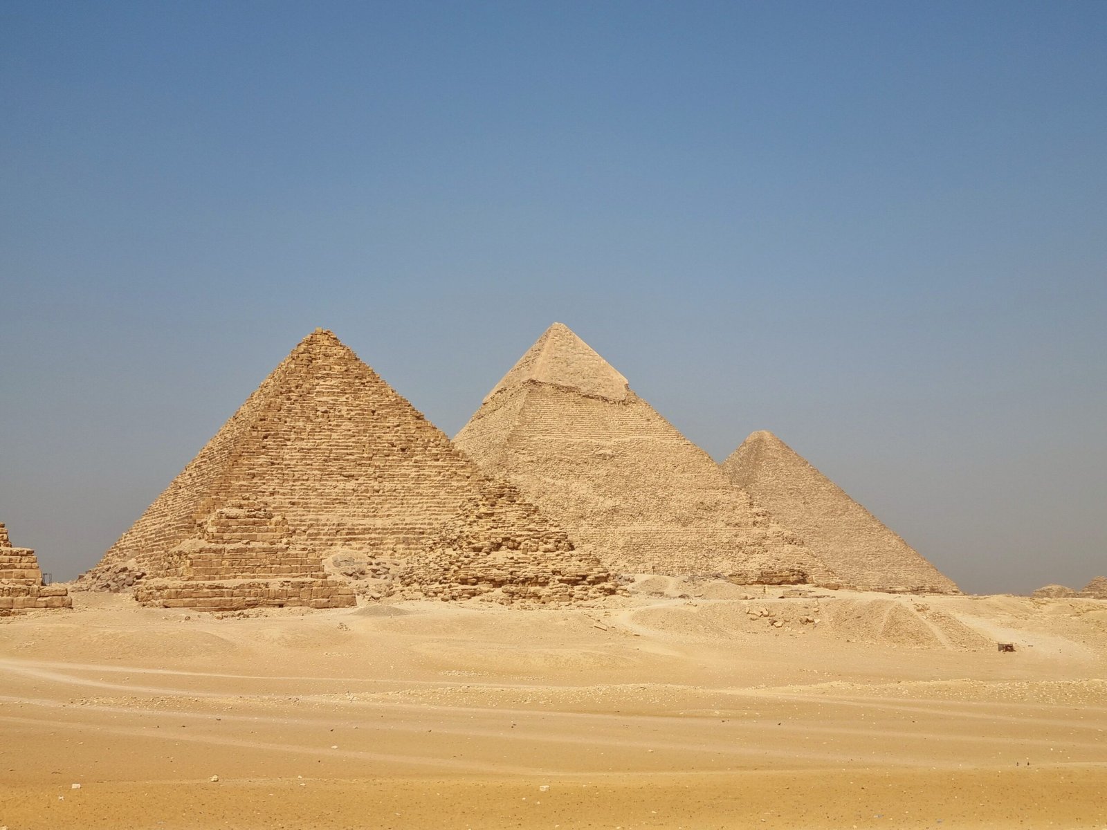 A stunning view of the Pyramids of Giza under a clear blue sky, showcasing Egypt's ancient heritage.
