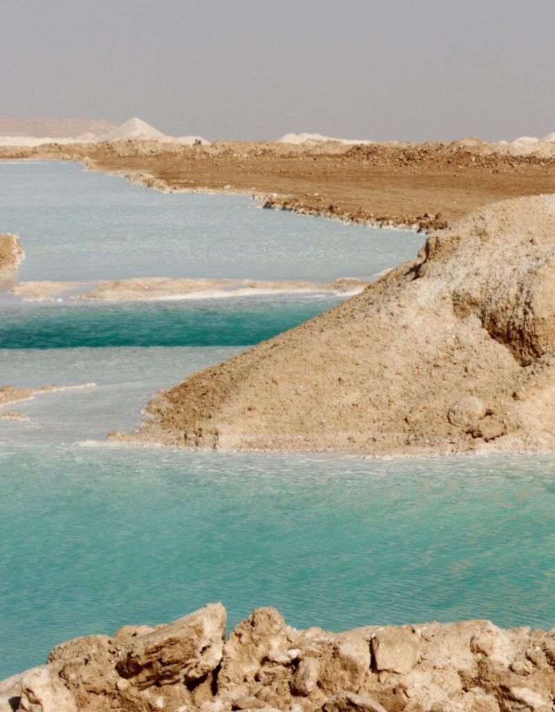 Explore a stunning coastal view with turquoise waters and rocky shores.