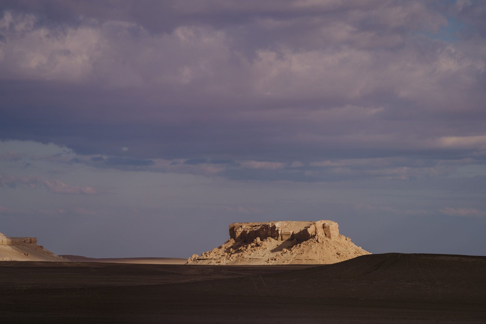 Explore the captivating rock formations of Faiyum, Egypt at sunset, showcasing natural desert beauty.