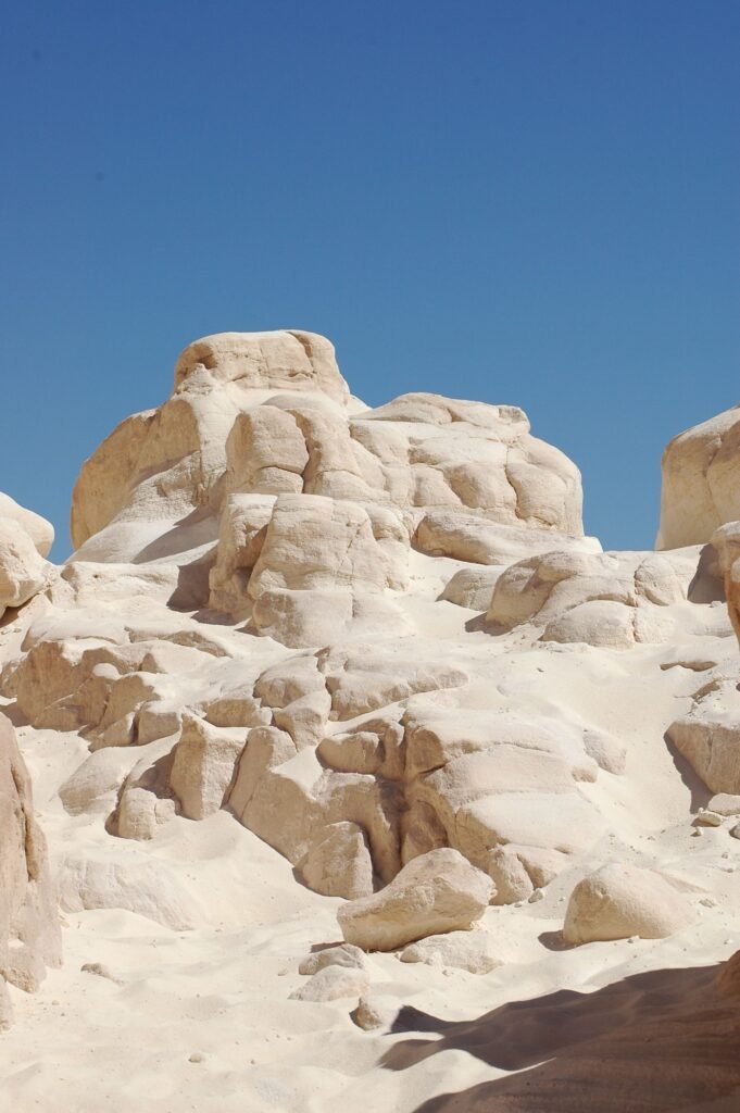 Captivating rock formations in the White Desert under a vivid blue sky offering an ethereal landscape.