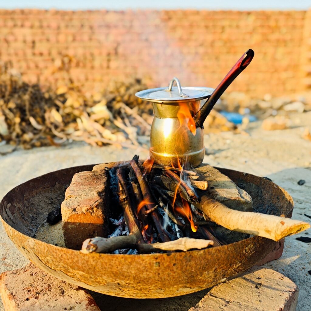 Authentic Egyptian tea brewing on open fire in Giza, capturing cultural essence.